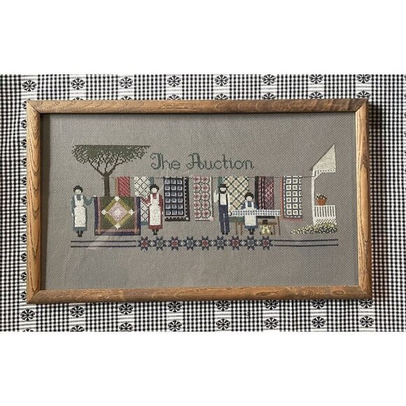 Framed Folk Art Cross Stitch “The Auction” Quilts Amish Country Primitive 19x11 - Picture 1 of 8